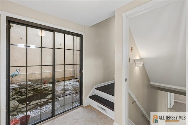 doorway to outside featuring tile patterned floors