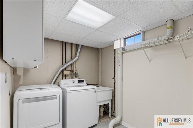 clothes washing area with cabinet space and washer and clothes dryer