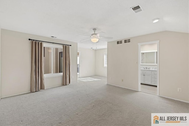 interior space featuring carpet floors, ceiling fan, and visible vents