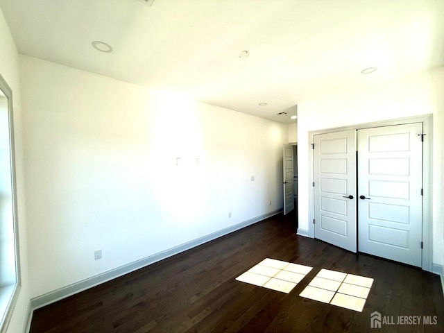 47 Bird Ave, Iselin, NJ 08830 - unfurnished bedroom featuring dark wood-style flooring, baseboards, a closet, and recessed lighting