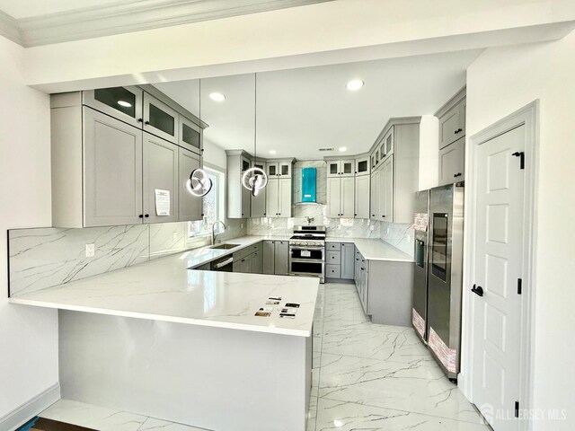 kitchen featuring stainless steel appliances, a peninsula, a sink, gray cabinetry, and marble finish floor