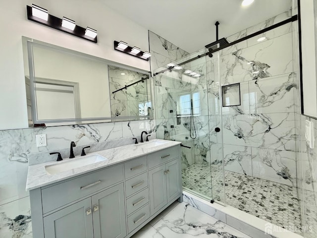 bathroom featuring a marble finish shower, a sink, double vanity, tile walls, and marble finish floor