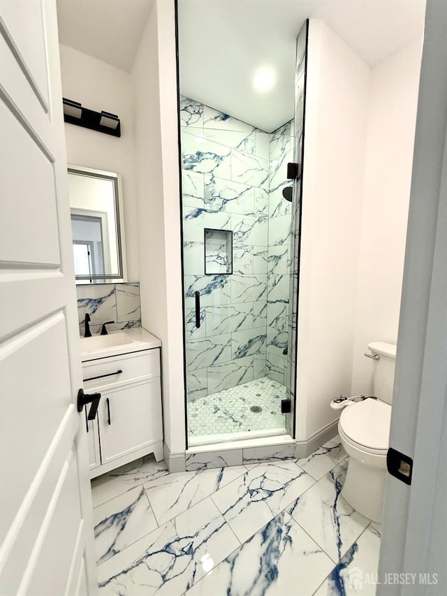 bathroom with vanity, marble finish floor, baseboards, and a marble finish shower