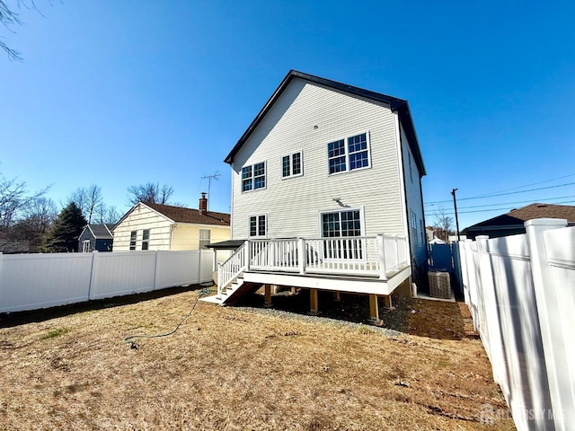 back of house with a wooden deck and a fenced backyard