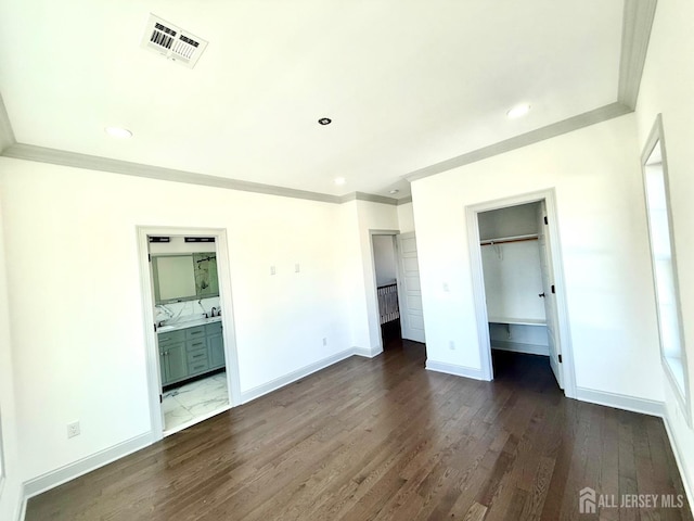 47 Bird Ave, Iselin, NJ 08830 - unfurnished bedroom featuring a walk in closet, ornamental molding, dark wood-style flooring, baseboards, and a closet