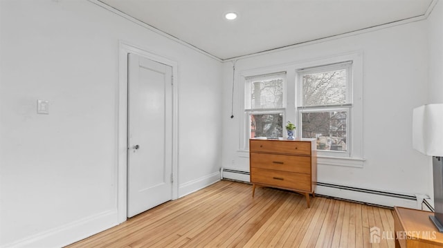 spare room featuring light wood finished floors and baseboards