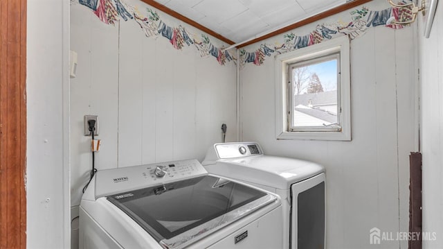 laundry room with washer and dryer, laundry area, and wood walls