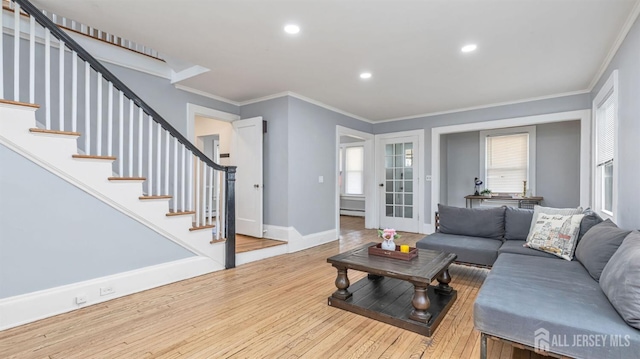 living room featuring crown molding, stairway, baseboards, and wood finished floors