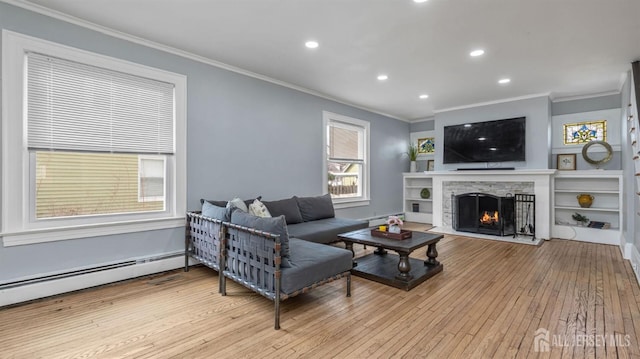 living room featuring crown molding, a fireplace, recessed lighting, wood-type flooring, and a baseboard heating unit