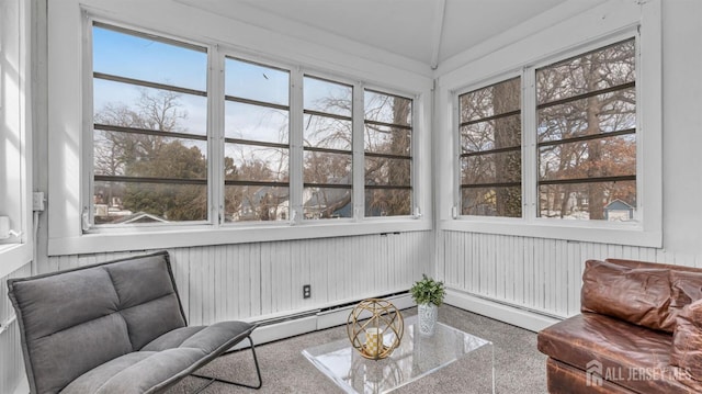 sunroom featuring a wealth of natural light, lofted ceiling, and baseboard heating