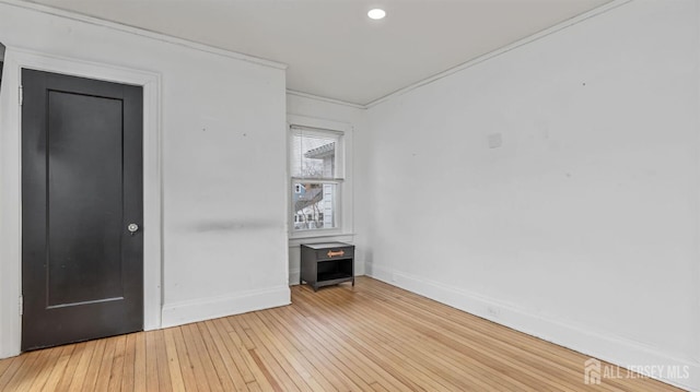 unfurnished room with light wood-style flooring and baseboards