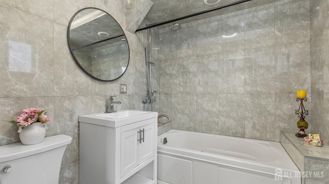 full bath with toilet, shower / bathtub combination, vanity, and tile walls