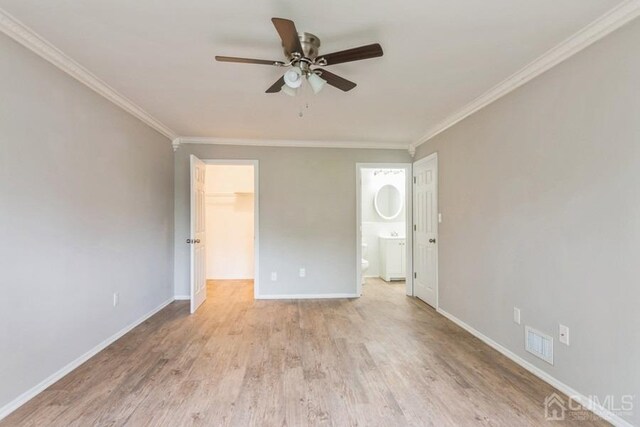 unfurnished bedroom featuring ornamental molding, baseboards, visible vents, and light wood finished floors