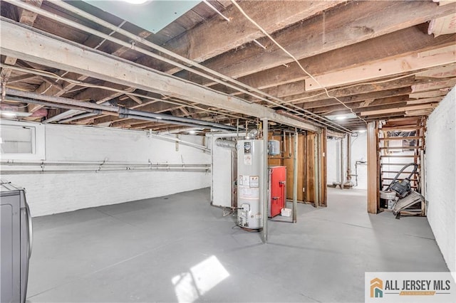 unfinished below grade area featuring washer / dryer and gas water heater