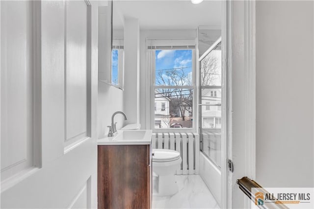 full bath featuring toilet, bathing tub / shower combination, vanity, marble finish floor, and radiator heating unit