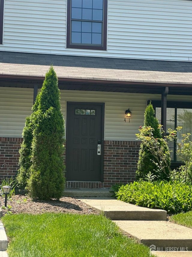 41 Aspen Dr, North Brunswick, NJ 08902 - entrance to property with brick siding and covered porch