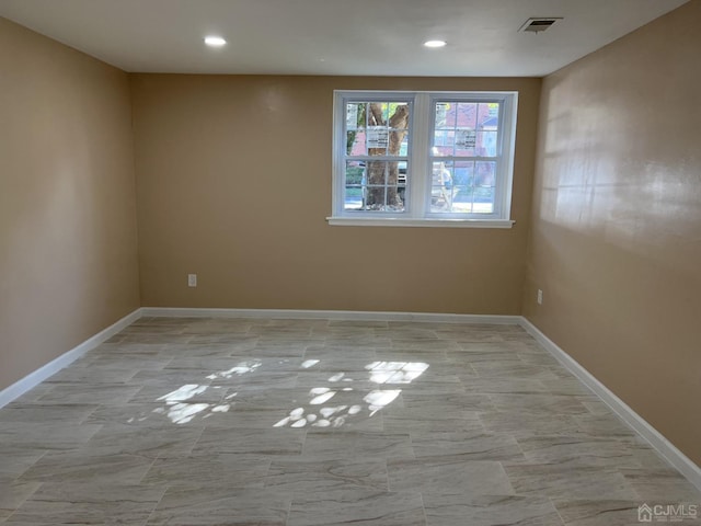 empty room featuring recessed lighting, visible vents, and baseboards