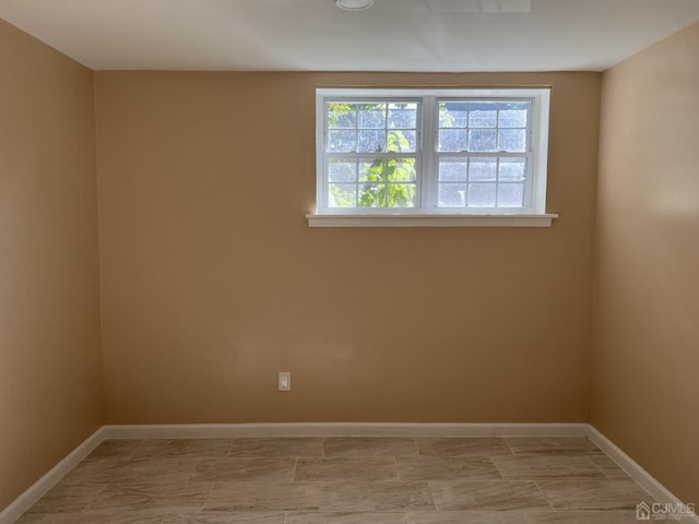 unfurnished room featuring baseboards