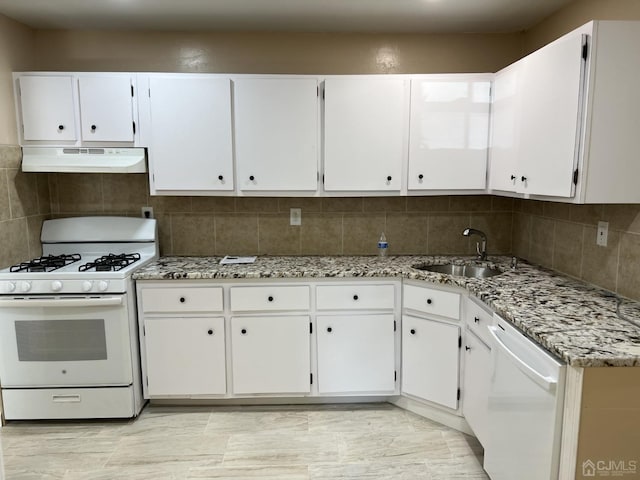 kitchen with under cabinet range hood, white appliances, a sink, white cabinetry, and backsplash