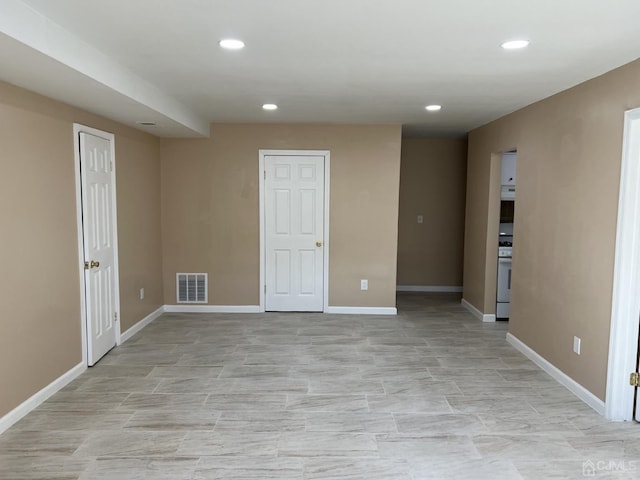 below grade area featuring baseboards, visible vents, and recessed lighting