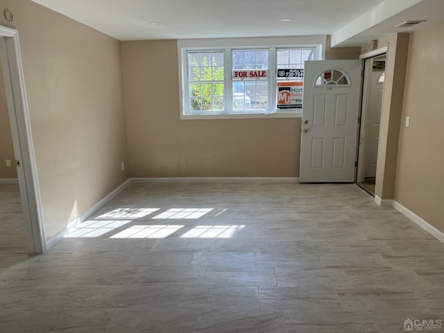 unfurnished room with visible vents and baseboards