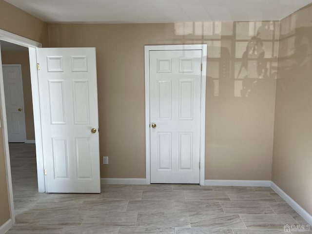 unfurnished bedroom featuring baseboards