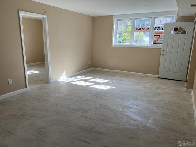 unfurnished room featuring visible vents and baseboards