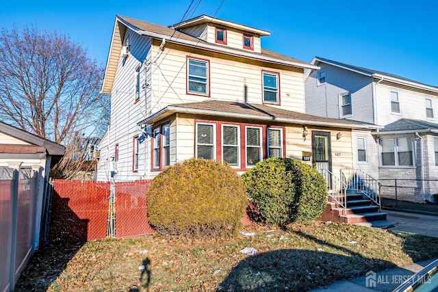 traditional style home featuring fence