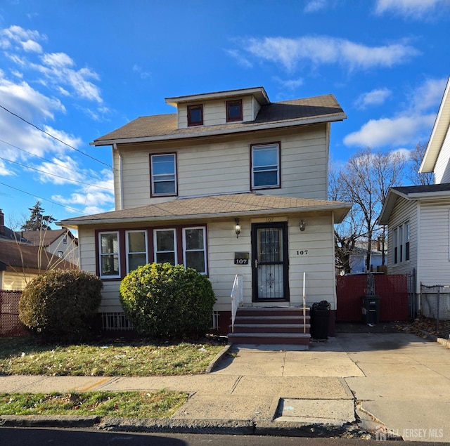 american foursquare style home with fence