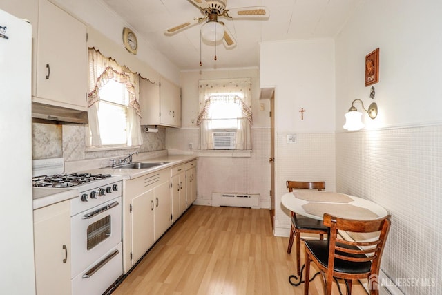1107 River Rd, Piscataway, NJ 08854 - kitchen with a baseboard radiator, white appliances, a sink, ventilation hood, and ceiling fan