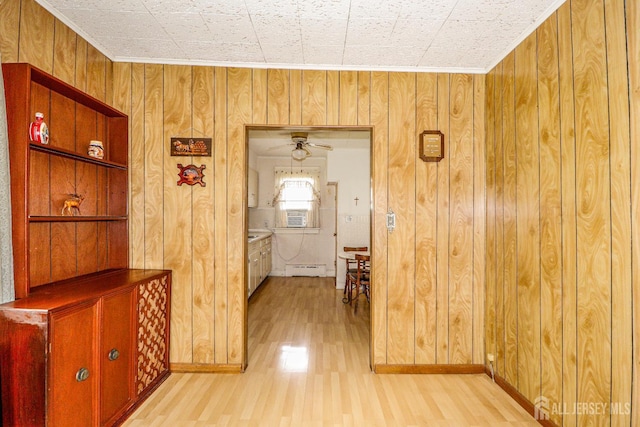 1107 River Rd, Piscataway, NJ 08854 - hallway featuring light wood-style floors, wood walls, a baseboard radiator, crown molding, and baseboards