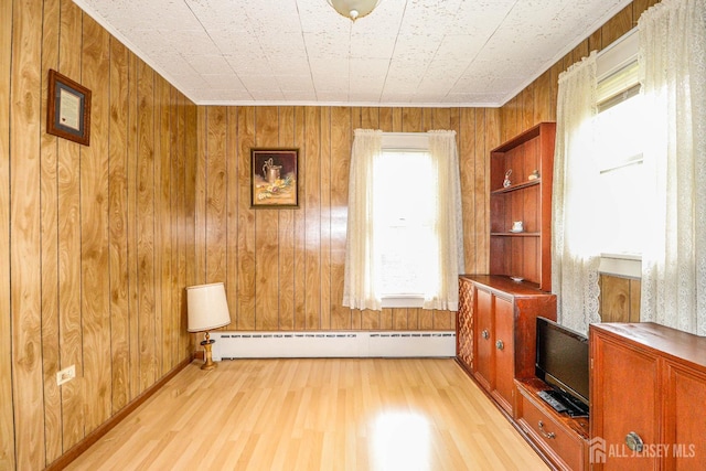 1107 River Rd, Piscataway, NJ 08854 - unfurnished living room with baseboard heating, light wood-type flooring, and wood walls