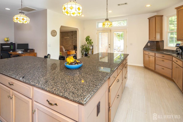 294 Fresh Pond Rd, South Brunswick, NJ 08902 - kitchen featuring french doors, recessed lighting, a center island, decorative light fixtures, and dark stone countertops