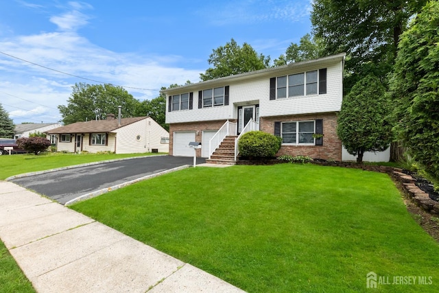 45 Kenmore Rd, Edison, NJ 08817 - bi-level home with driveway, brick siding, a garage, and a front lawn