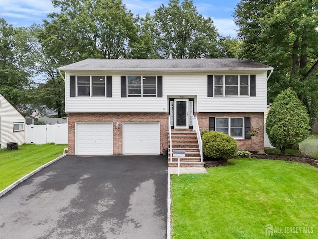 45 Kenmore Rd, Edison, NJ 08817 - split foyer home with brick siding, driveway, and a garage