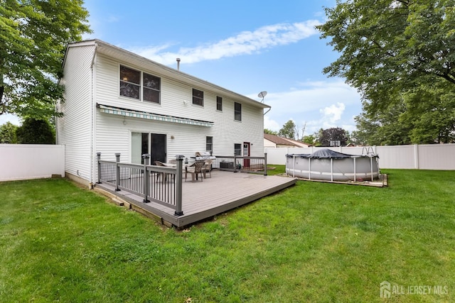 45 Kenmore Rd, Edison, NJ 08817 - rear view of house with a fenced backyard and a wooden deck