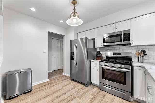 45 Kenmore Rd, Edison, NJ 08817 - kitchen featuring appliances with stainless steel finishes, light wood-style floors, white cabinetry, decorative backsplash, and recessed lighting