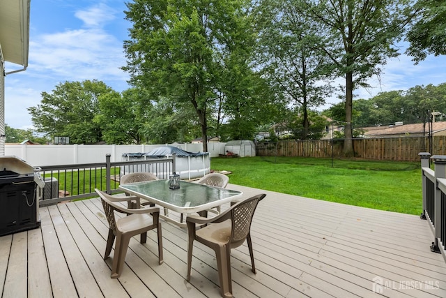 45 Kenmore Rd, Edison, NJ 08817 - wooden terrace with outdoor dining area, a fenced backyard, and a shed