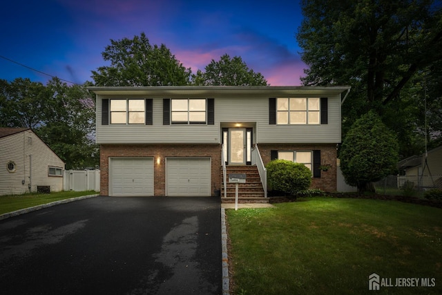 45 Kenmore Rd, Edison, NJ 08817 - raised ranch featuring brick siding, driveway, a garage, and entry steps