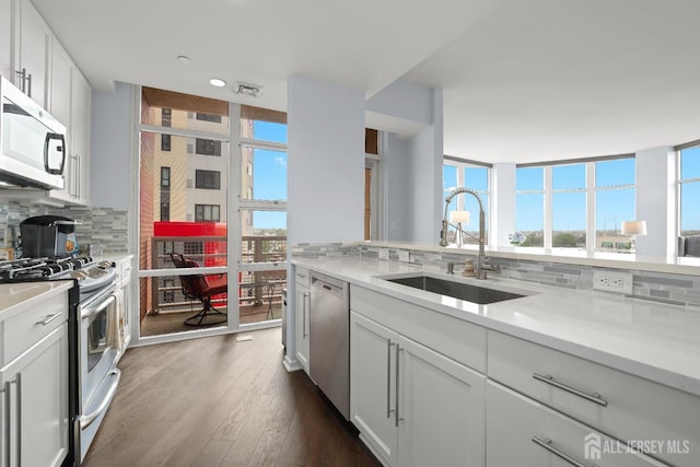 20 Livingston Ave Unit 601, New Brunswick, NJ 08901 - kitchen with appliances with stainless steel finishes, backsplash, light countertops, plenty of natural light, and recessed lighting