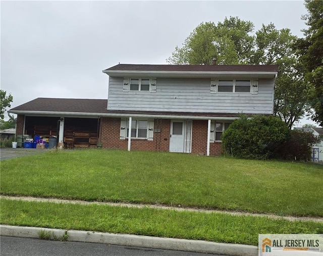 41 Raleigh Rd, South Brunswick, NJ 08824 - view of front of property featuring an attached garage, a front lawn, brick siding, and driveway