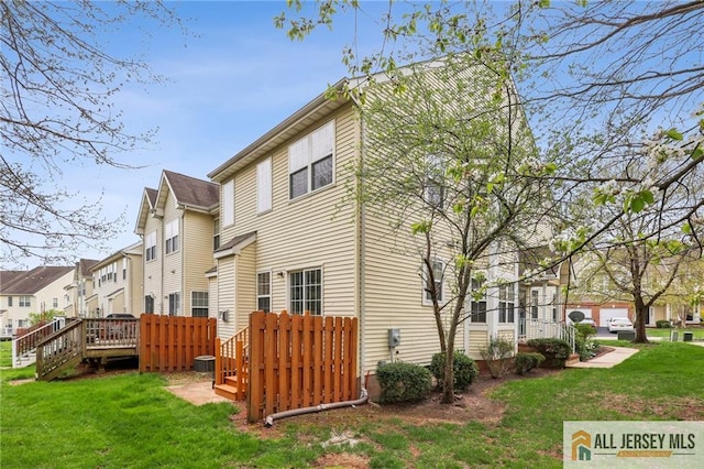 1115 Joseph Ct, South Plainfield, NJ 07080 - back of house with a lawn, a residential view, and a wooden deck