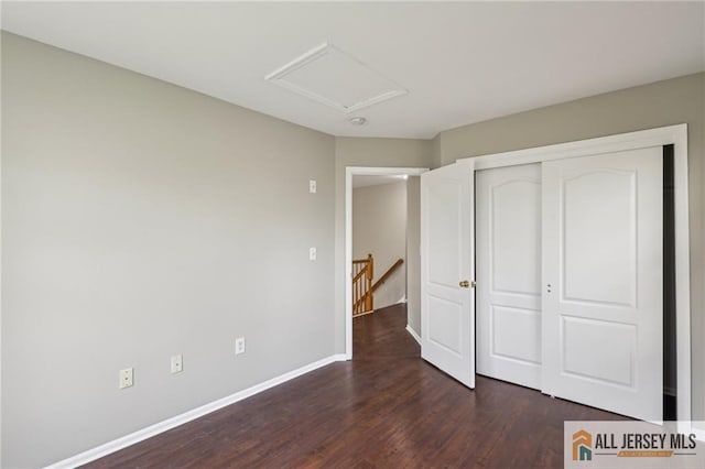 1115 Joseph Ct, South Plainfield, NJ 07080 - unfurnished bedroom featuring dark wood-style floors, a closet, attic access, and baseboards