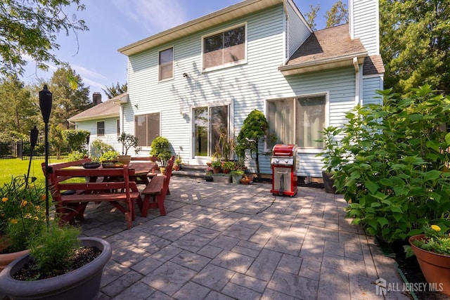 10 Chelsea Ct, South Brunswick, NJ 08810 - back of house with a patio area and a chimney
