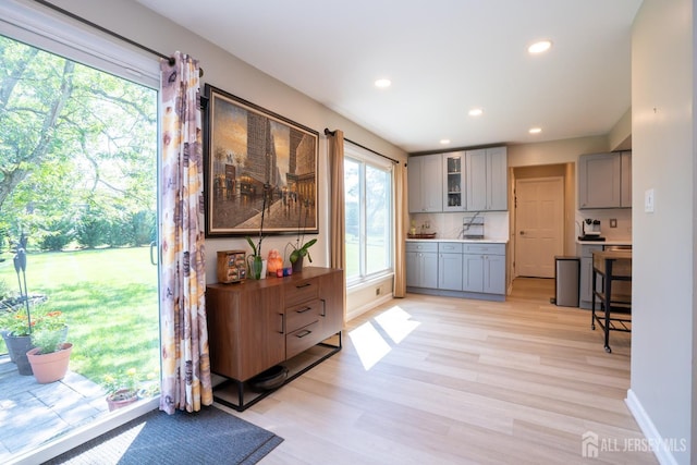 10 Chelsea Ct, South Brunswick, NJ 08810 - kitchen with gray cabinets, light wood-style floors, glass insert cabinets, recessed lighting, and decorative backsplash