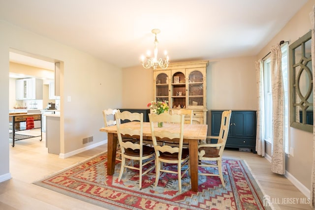 10 Chelsea Ct, South Brunswick, NJ 08810 - dining room with a chandelier and light wood-style flooring