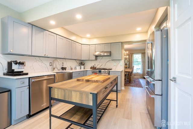 10 Chelsea Ct, South Brunswick, NJ 08810 - kitchen featuring appliances with stainless steel finishes, under cabinet range hood, light wood-type flooring, light countertops, and recessed lighting
