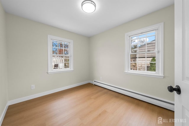 651 Myrtle Rd, North Brunswick, NJ 08902 - unfurnished room with a baseboard radiator, wood finished floors, and plenty of natural light