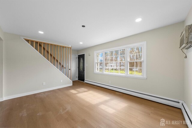 651 Myrtle Rd, North Brunswick, NJ 08902 - unfurnished living room with a baseboard radiator, stairs, wood finished floors, and recessed lighting