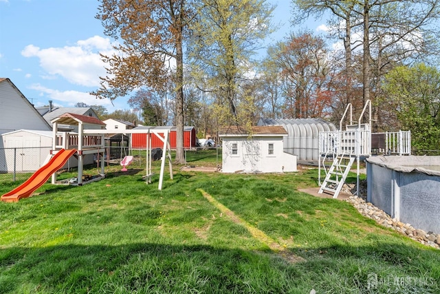 651 Myrtle Rd, North Brunswick, NJ 08902 - view of yard featuring a storage unit, a playground, an outdoor structure, and an outdoor pool